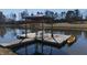 Wooden dock with gazebo, table and chairs, and kayak at 5765 G Snow Camp Rd, Graham, NC 27253