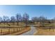 Gravel driveway leading to home with pond and trees at 5765 G Snow Camp Rd, Graham, NC 27253
