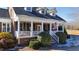 Front porch view of charming brick home with white columns at 5765 G Snow Camp Rd, Graham, NC 27253