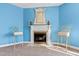 Fireplace with ornate mirror and two ornate chairs at 5765 G Snow Camp Rd, Graham, NC 27253