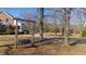 Rustic wooden swing in front yard of charming brick home at 5765 G Snow Camp Rd, Graham, NC 27253