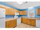 Kitchen with light wood cabinets, tile floors, and modern appliances at 5765 G Snow Camp Rd, Graham, NC 27253