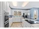 Modern kitchen with white cabinets and stainless steel appliances at 5765 G Snow Camp Rd, Graham, NC 27253