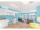 Bright kitchen features white cabinets, tile floors, and a view into a sunroom at 5765 G Snow Camp Rd, Graham, NC 27253