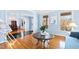 Open living space with hardwood floors, light blue walls, and a view to dining area at 5765 G Snow Camp Rd, Graham, NC 27253