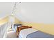 Loft bedroom with two twin beds and a sloped ceiling at 5765 G Snow Camp Rd, Graham, NC 27253