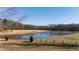 Tranquil pond view with dock and surrounding landscape at 5765 G Snow Camp Rd, Graham, NC 27253