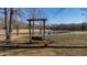 Rustic swing overlooking a pond and scenic landscape at 5765 G Snow Camp Rd, Graham, NC 27253