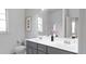 Bathroom with double vanity, gray cabinets, and a shower at 613 Emerald Bay Cir, Raleigh, NC 27610