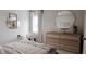 Bedroom with a round mirror and large dresser at 613 Emerald Bay Cir, Raleigh, NC 27610