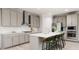 Modern kitchen with gray cabinets, white quartz countertops, and stainless steel appliances at 613 Emerald Bay Cir, Raleigh, NC 27610