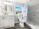 Clean bathroom, featuring a shower, white vanity, and updated fixtures at 6307 Tryon Rd, Cary, NC 27518