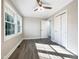 Bright bedroom with hardwood floors, ceiling fan and neutral walls at 6307 Tryon Rd, Cary, NC 27518