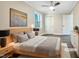 Virtually staged bedroom with a queen bed, wood floors, and neutral walls at 6307 Tryon Rd, Cary, NC 27518