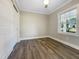 Bright bedroom with wood-look floors, double doors, and a window at 6307 Tryon Rd, Cary, NC 27518
