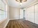 Spacious bedroom with wood-look floors and double doors at 6307 Tryon Rd, Cary, NC 27518