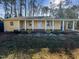 Cute yellow house with a front porch, and nicely landscaped yard at 6307 Tryon Rd, Cary, NC 27518