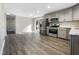 Open concept kitchen with stainless steel appliances and hardwood floors at 6307 Tryon Rd, Cary, NC 27518