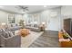 Virtually staged living room with gray sofas, wood coffee table, and hardwood floors at 6307 Tryon Rd, Cary, NC 27518