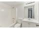 Clean, all-white bathroom with a shower-tub combo and a vanity with storage at 642 Pine Ridge Pl, Raleigh, NC 27609
