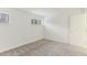This bedroom features neutral carpet, white walls, and natural light through two windows at 642 Pine Ridge Pl, Raleigh, NC 27609
