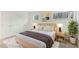 Cozy bedroom with a comfortable bed, stylish nightstands, a green plant, and a large window at 642 Pine Ridge Pl, Raleigh, NC 27609