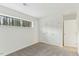 This bedroom features neutral carpet, white walls, one window and double door closet at 642 Pine Ridge Pl, Raleigh, NC 27609