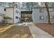 Attractive condo building with covered walkways, exterior stairs and mature trees surrounded by a well-kept lawn at 642 Pine Ridge Pl, Raleigh, NC 27609