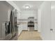 Modern kitchen with stainless steel appliances, light countertops, and bright white cabinets at 642 Pine Ridge Pl, Raleigh, NC 27609