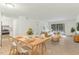 Bright and airy living and dining area with wood floors, modern furnishings, and sliding glass door to the outside at 642 Pine Ridge Pl, Raleigh, NC 27609
