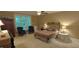 Spacious bedroom with two armchairs and a queen-size bed at 7115 Laurel Point Dr, Gibsonville, NC 27249