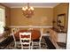 Elegant dining room featuring a large table, chandelier, and hardwood floors at 7115 Laurel Point Dr, Gibsonville, NC 27249
