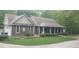 Two-story house with stone accents and a covered porch at 7115 Laurel Point Dr, Gibsonville, NC 27249