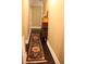 Long hallway with dark hardwood floors and colorful rug at 7115 Laurel Point Dr, Gibsonville, NC 27249