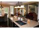 Open kitchen with island, granite countertops, and view to living room at 7115 Laurel Point Dr, Gibsonville, NC 27249