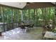 Screened porch with wooded views and a dining set at 7115 Laurel Point Dr, Gibsonville, NC 27249