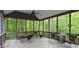 Spacious screened porch with wooded views and seating at 7115 Laurel Point Dr, Gibsonville, NC 27249