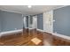Hardwood floor bedroom with blue walls and access to back porch at 801 N Mebane St, Burlington, NC 27217