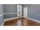 Spacious bedroom with hardwood floors and neutral walls at 801 N Mebane St, Burlington, NC 27217