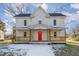 Two-story home with a red front door and wrap-around porch at 801 N Mebane St, Burlington, NC 27217