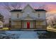 Two-story home with a red front door and wrap-around porch at 801 N Mebane St, Burlington, NC 27217