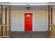 Red front door entrance with sidelights and a porch at 801 N Mebane St, Burlington, NC 27217