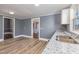 Kitchen with white cabinets, granite countertops, and stainless steel sink at 801 N Mebane St, Burlington, NC 27217
