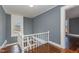 Upper-level landing with hardwood floors and white railings at 801 N Mebane St, Burlington, NC 27217