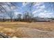 Vacant lot with gravel driveway and mature trees at 801 N Mebane St, Burlington, NC 27217