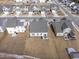 Aerial view showcasing houses' backyards and snowy lawns at 803 Golden Plum Ln, Zebulon, NC 27597