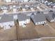 Aerial view of houses, showcasing backyards and snowy lawns at 803 Golden Plum Ln, Zebulon, NC 27597