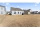 Spacious backyard with patio and partial view of neighboring homes at 803 Golden Plum Ln, Zebulon, NC 27597