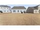 Spacious backyard with patio and partial view of neighboring homes at 803 Golden Plum Ln, Zebulon, NC 27597