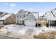 Two-story house with gray siding, attached garage, and snowy yard at 803 Golden Plum Ln, Zebulon, NC 27597
